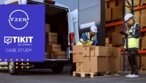 transportation workers wearing safety gear unloading boxes from the back of a van